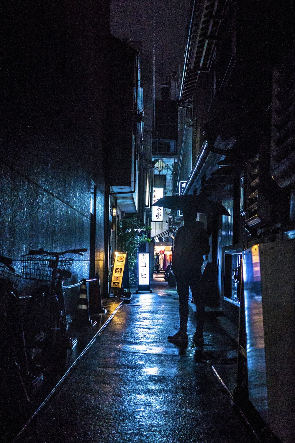man standing under umbrella at night