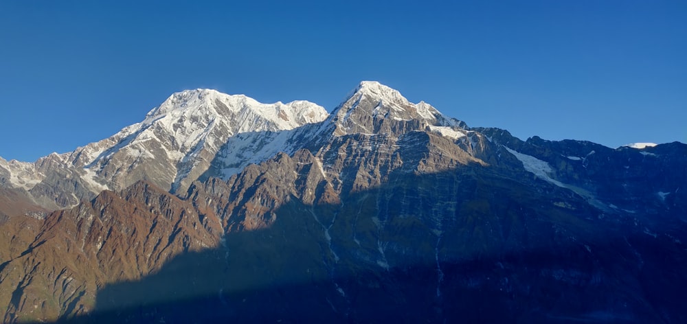 mountain and mountain covered with snow painting