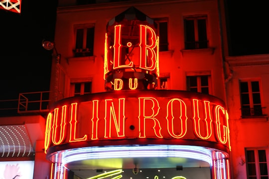 red and white wooden framed wall decor in Moulin Rouge France