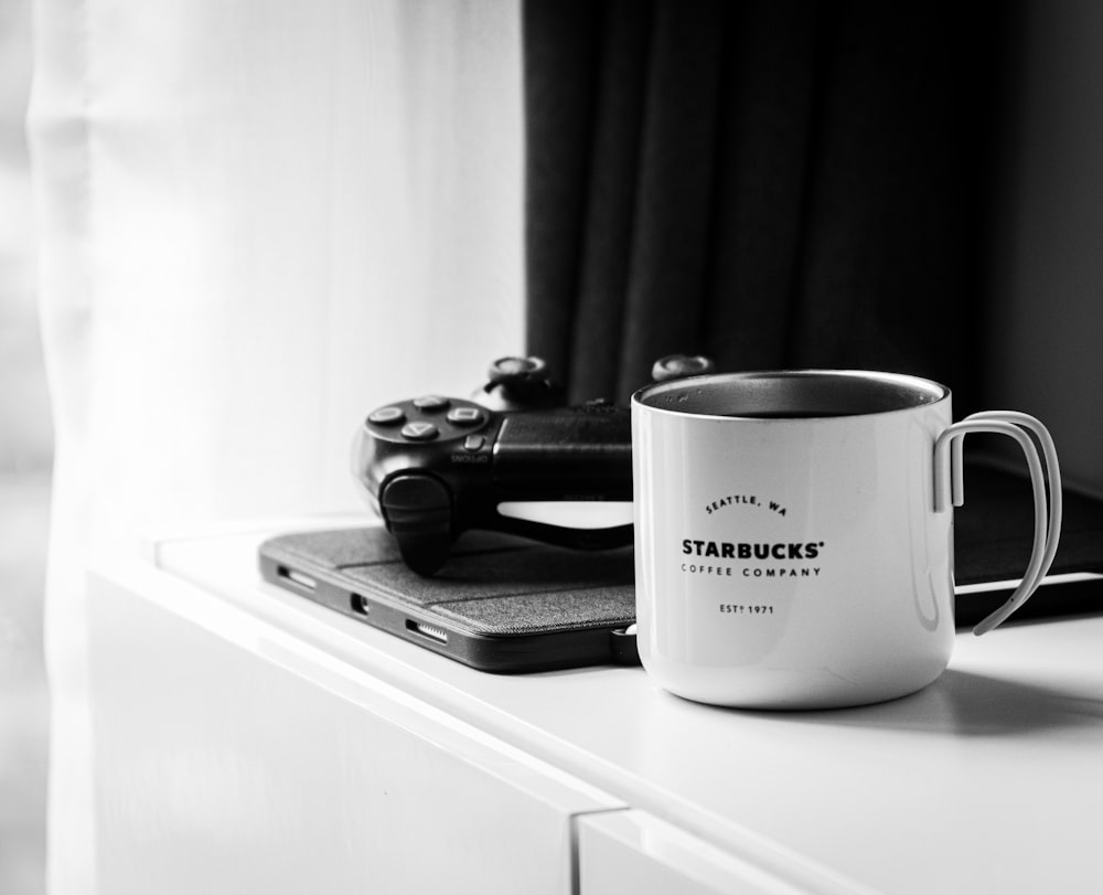 white and black ceramic mug