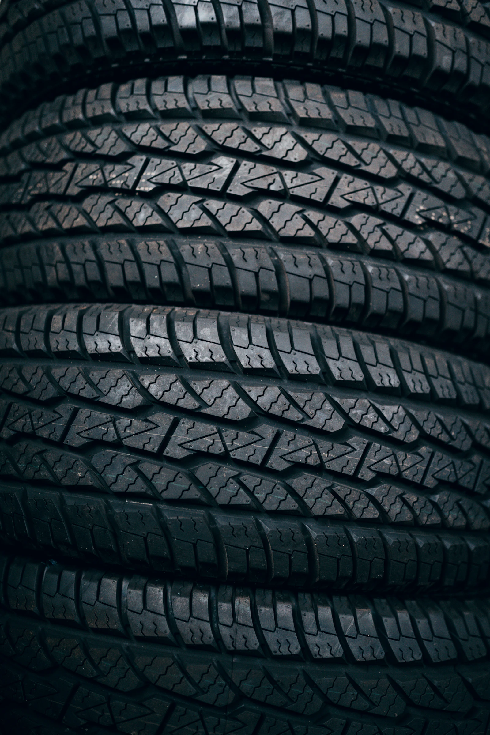 A set of four car tires stacked together