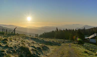 A serene sunrise over a misty mountain trail inviting early morning explorers.