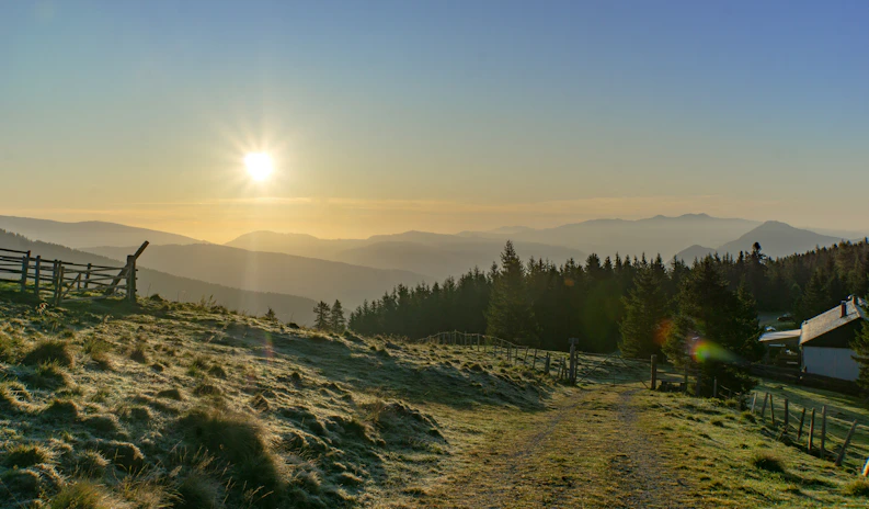 A serene sunrise over a quiet mountain trail, inviting solo adventurers to start their day with calm and clarity.