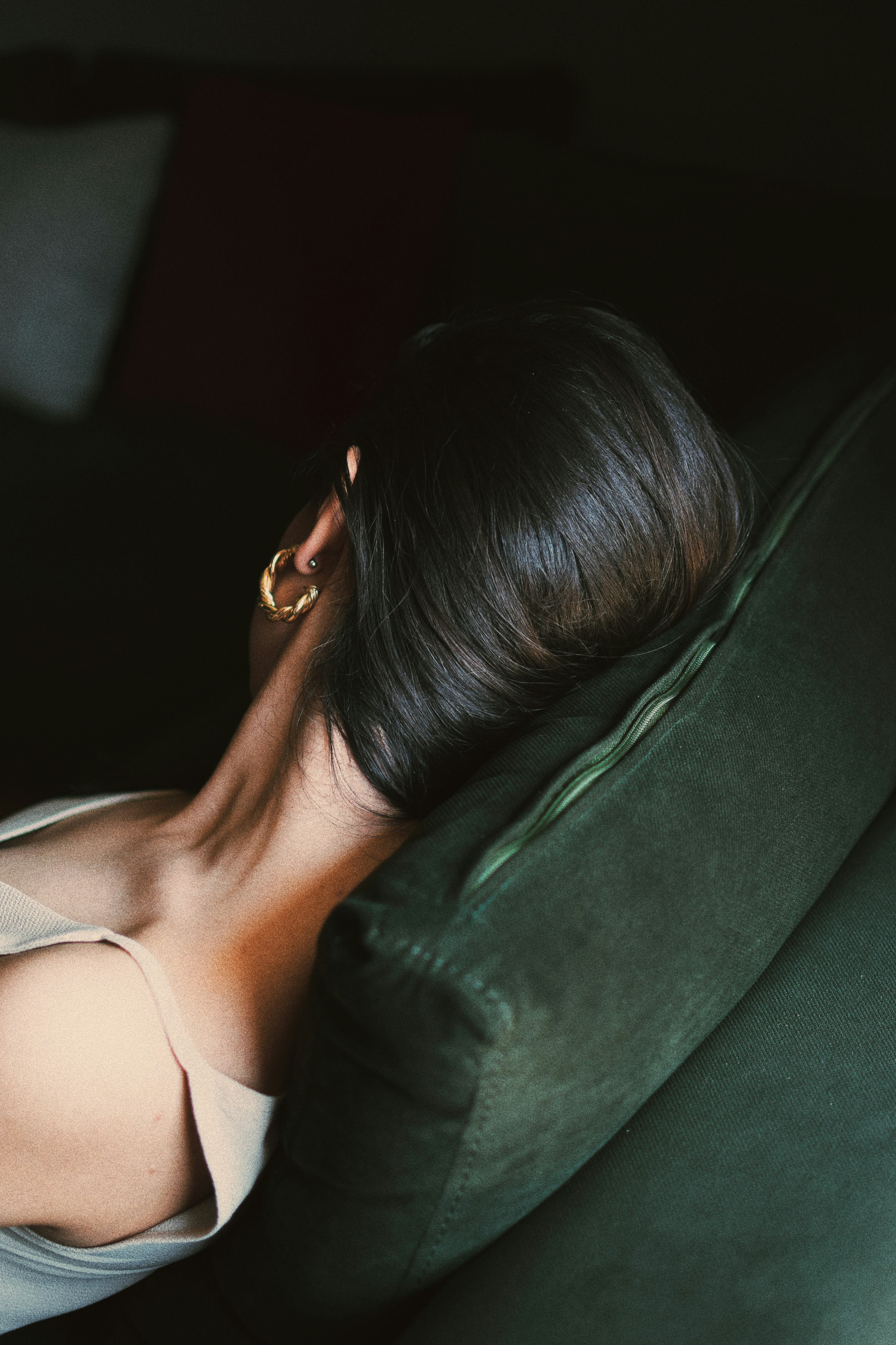 woman wearing gray top lying in bed