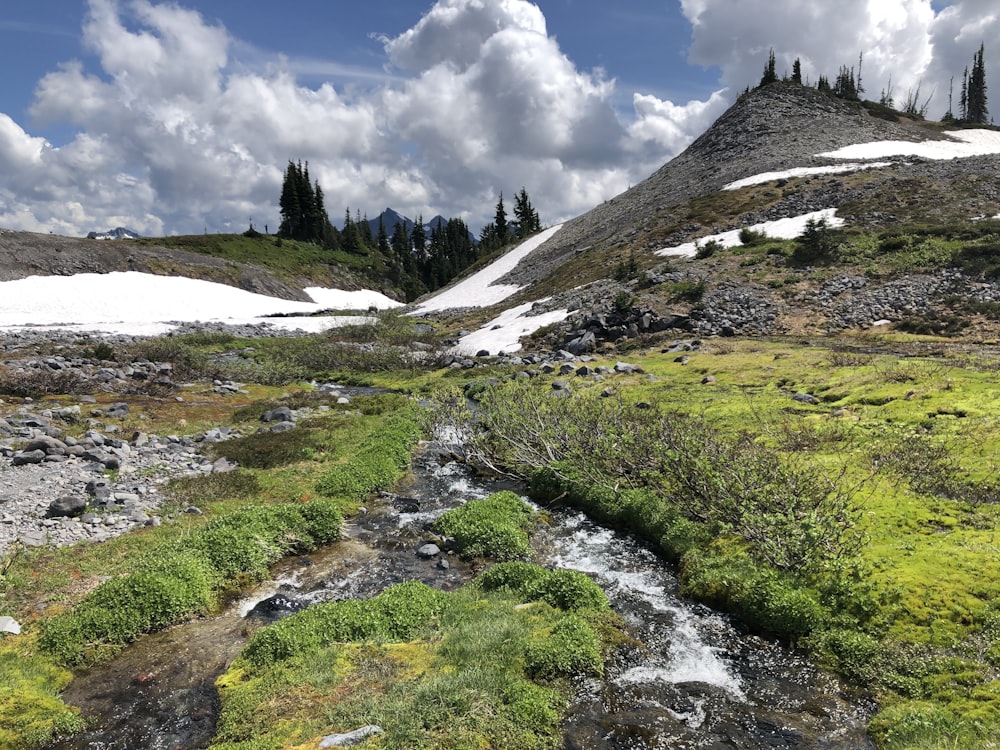 green mountain under white clouds