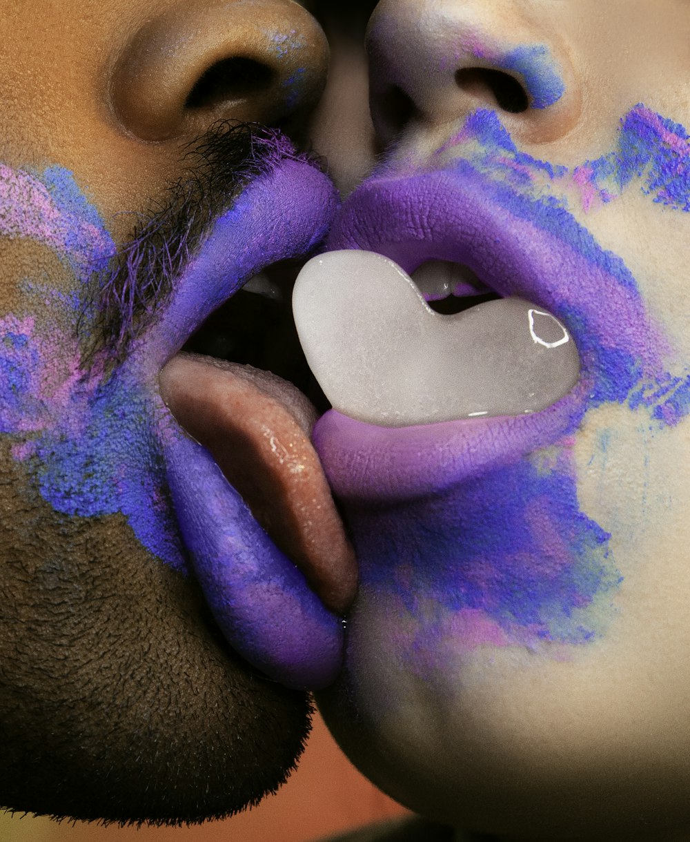 man licking woman's lip