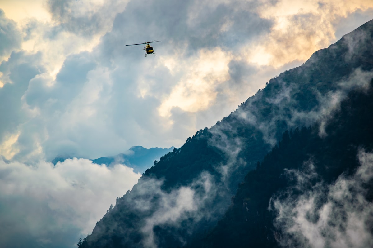 Helicopter flying over Himalayan mountains for Char Dham service