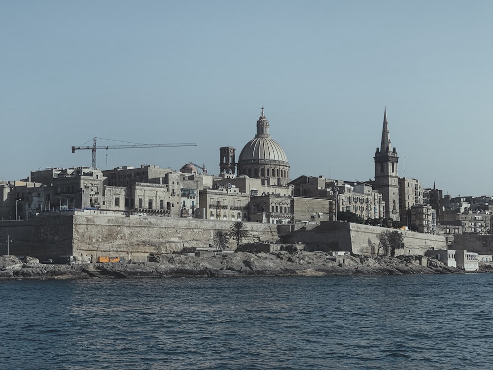 gray concrete dome building beside sea