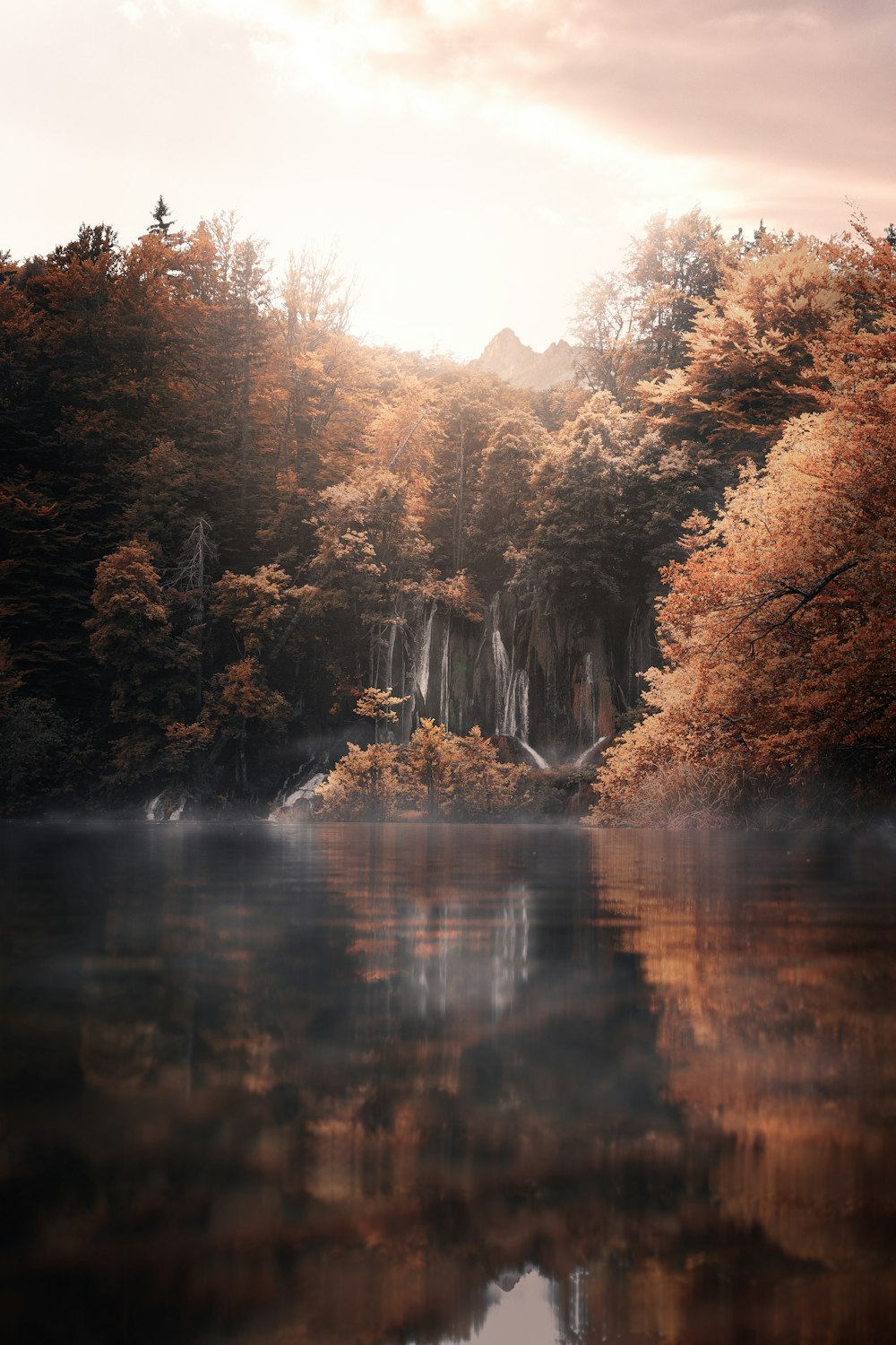 árvores de outono por uma paisagem de lago