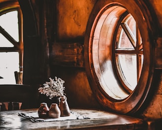 flower vase beside window