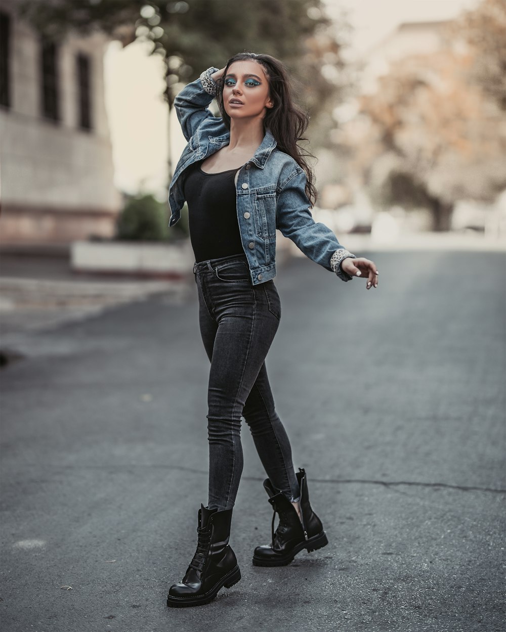 selective focus photo of woman standing on concrete street