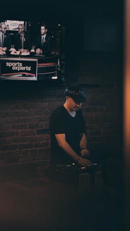 A passionate sports analyst reviewing match statistics on multiple screens.