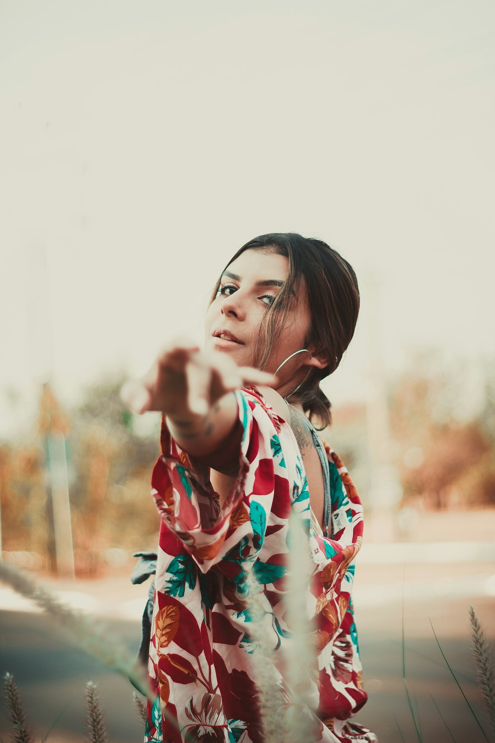 woman wearing brown and teal floral top