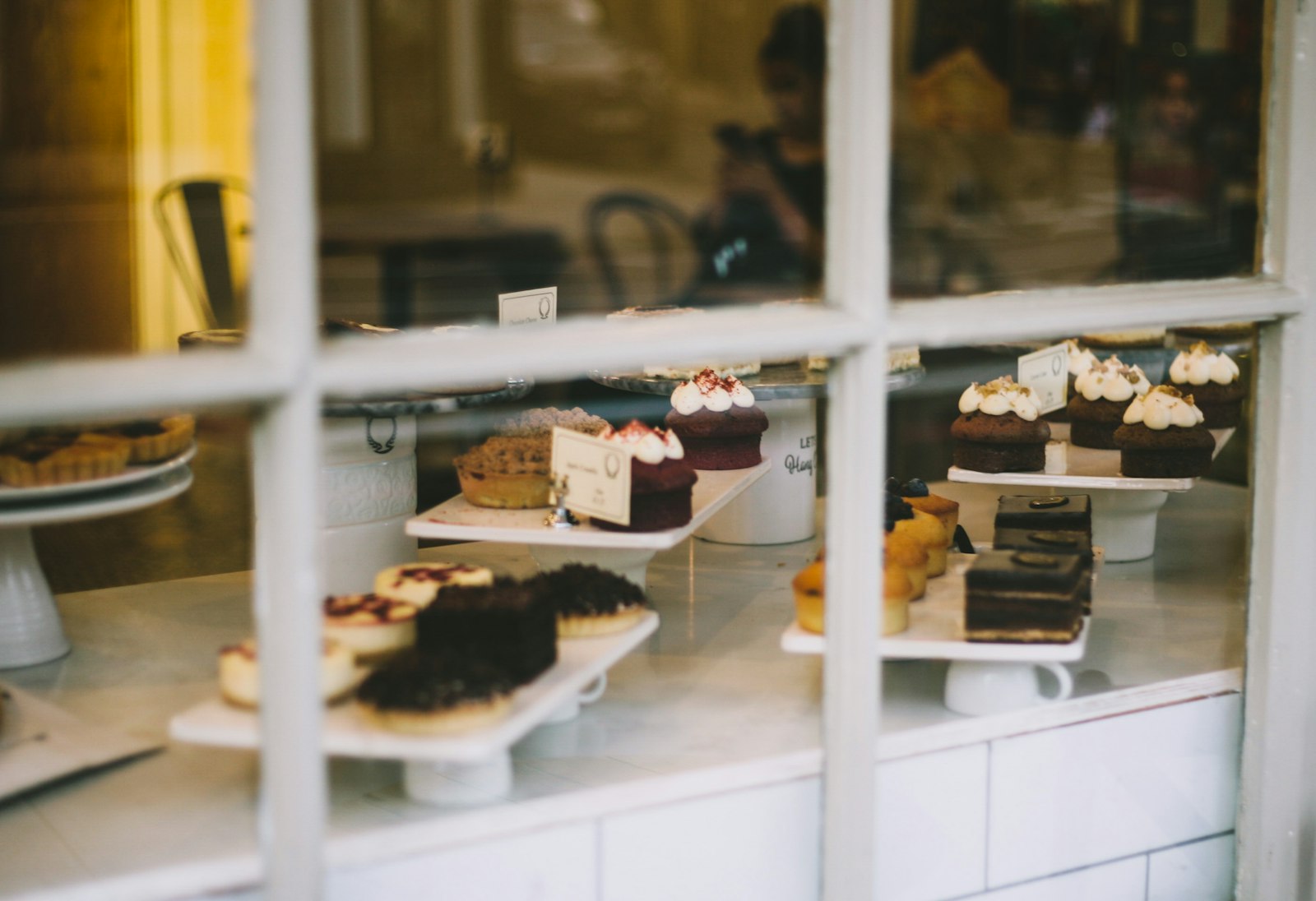 Canon EOS-1D Mark II + Canon EF 50mm F1.8 II sample photo. Assorted cakes near window photography