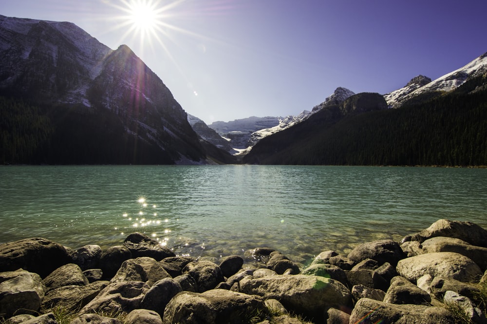 black and white mountain and body of water