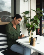 woman writing on desk