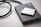 A solid-state drive is connected by a black cable, accompanied by a 256GB AV PRO CF card placed on top. The objects rest on a smooth, light-colored surface.