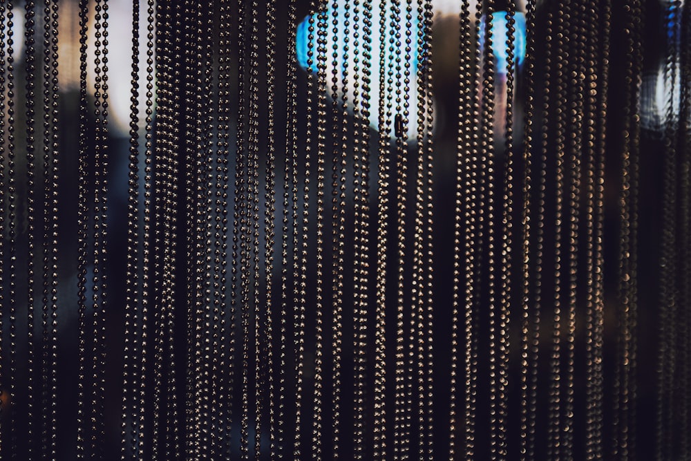 a close up of a metal curtain with beads