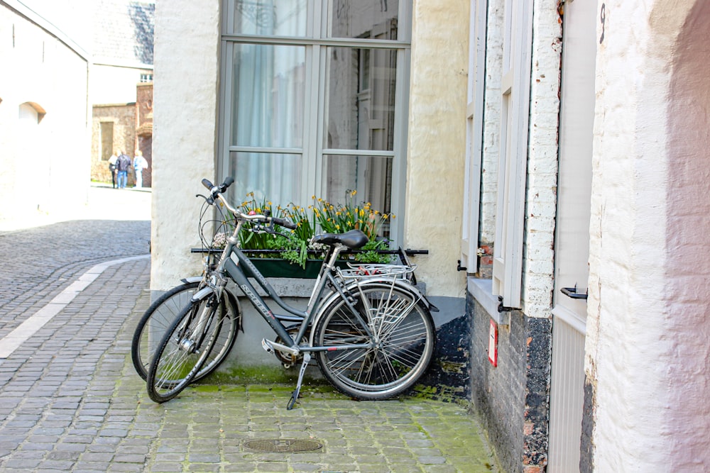 black bicycle beside window