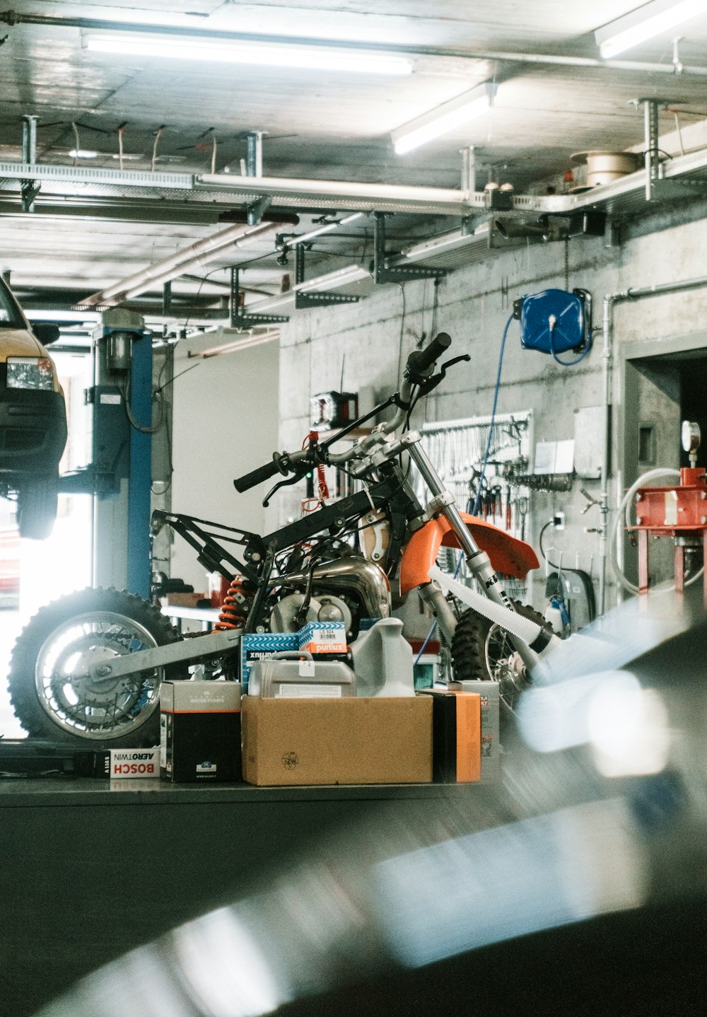 orange and black motorcycle inside shop