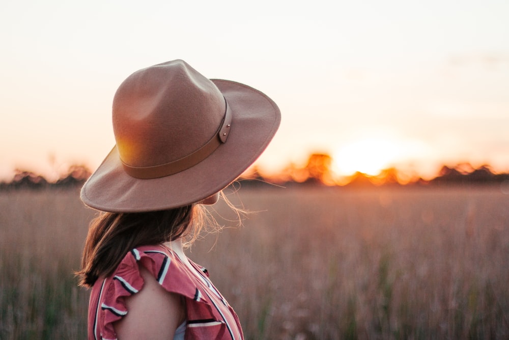 woman facing grass field