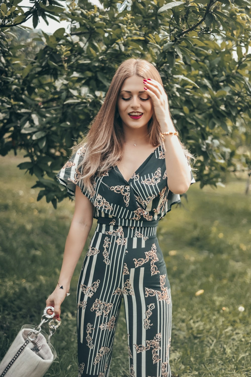 woman standing in front of green tree