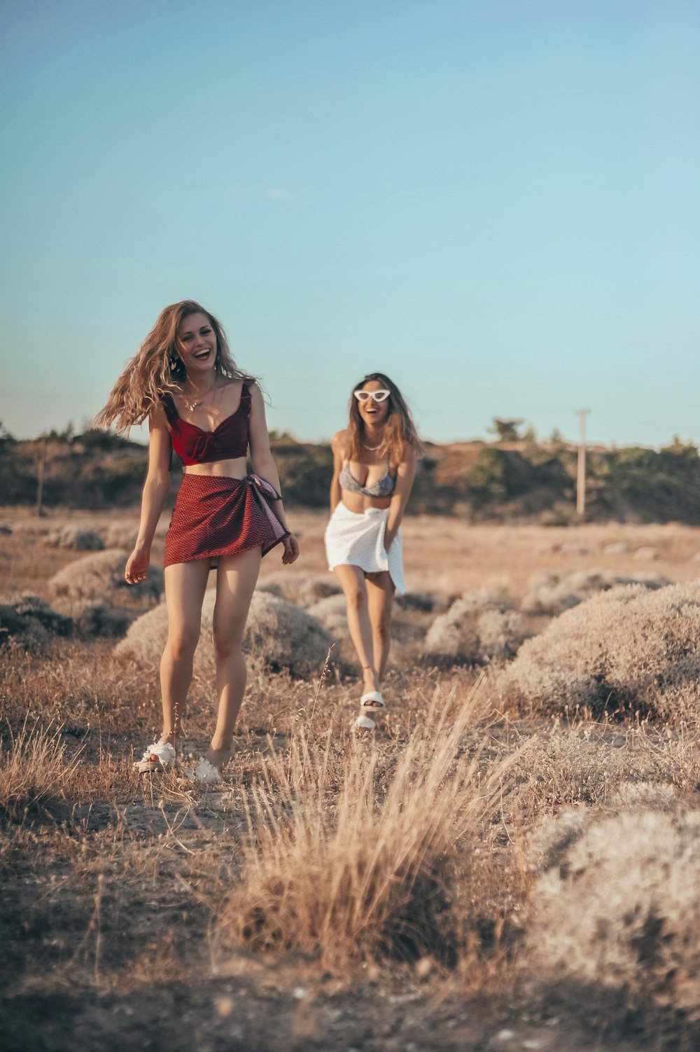 woman wears red dress walk on the field