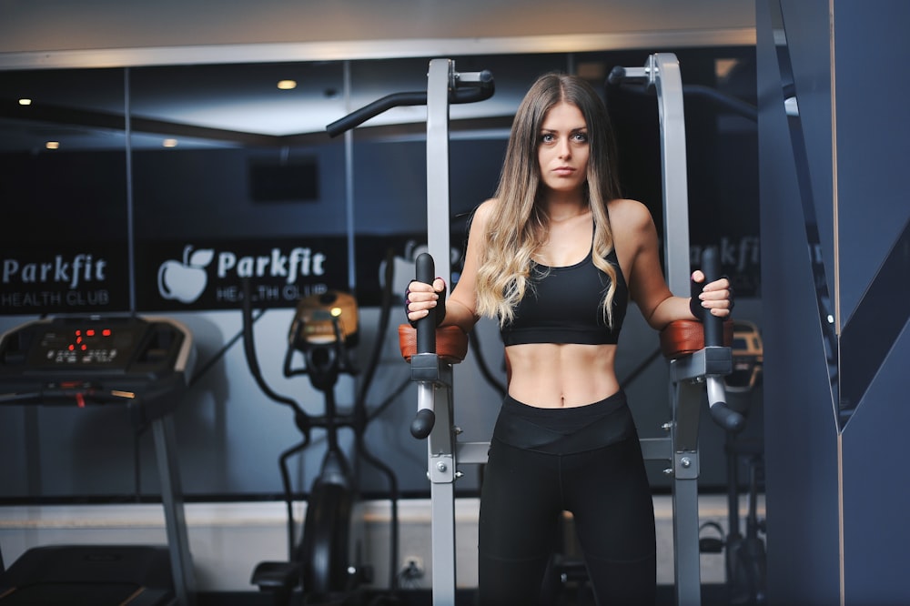 a woman in a black sports bra top and black leggings