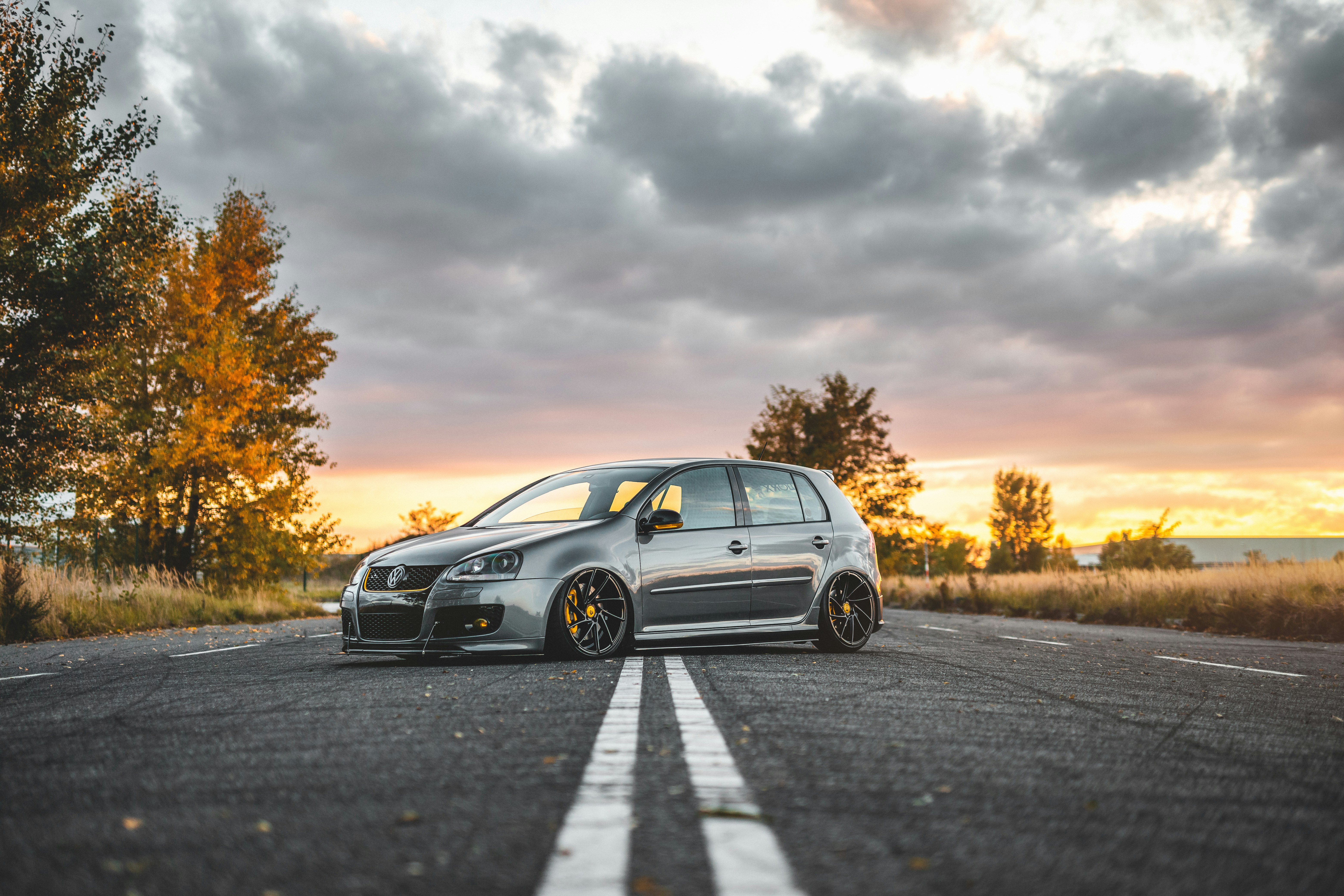 silver 5-door hatchback parked in the middle of the road during day