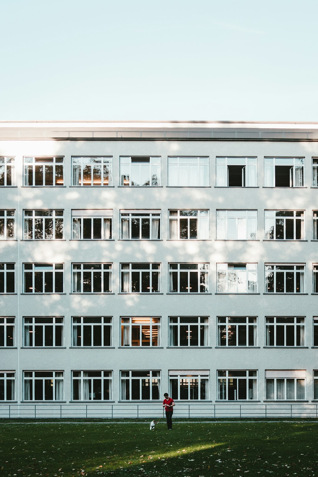 man standing beside building