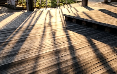 A freshly restored wooden deck and fence glowing in the sunlight.