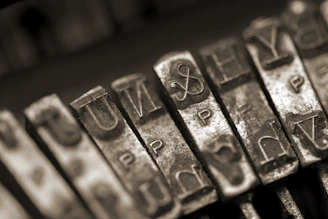 A close-up of a vintage typewriter keyboard with worn keys, symbolizing thoughtful creativity.