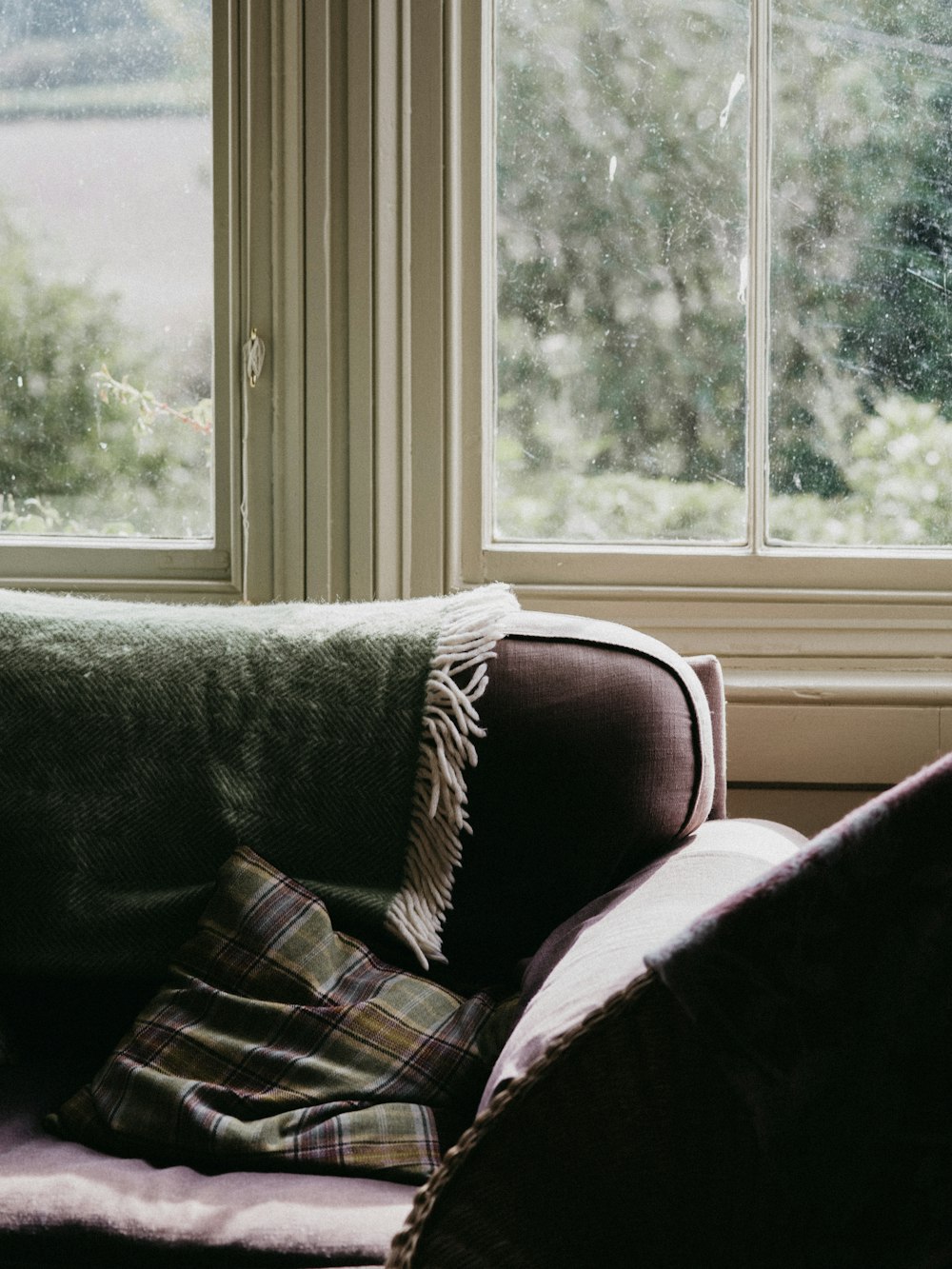 brown and green plaid pillow on sofa