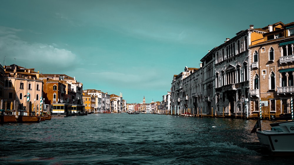 river with houses under blue sky