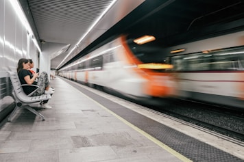time lapse photo of white and orange train