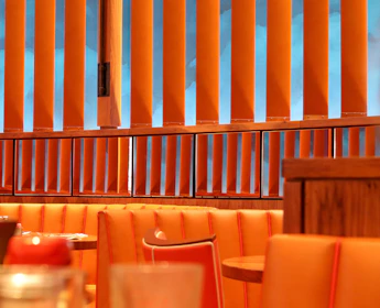 A vibrant photo of a cozy East Orange restaurant interior with warm lighting.