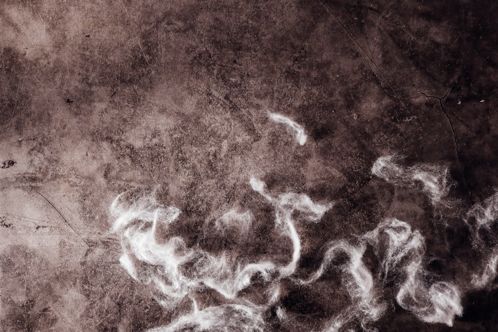 a black and white photo of smoke on a wall