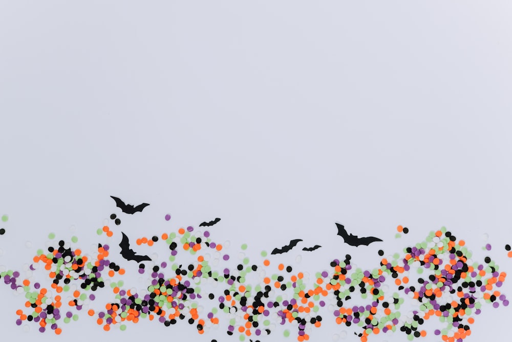 black bat and multicolored dots illustration