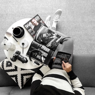 A person watching a tutorial on a tablet while relaxing on a couch.