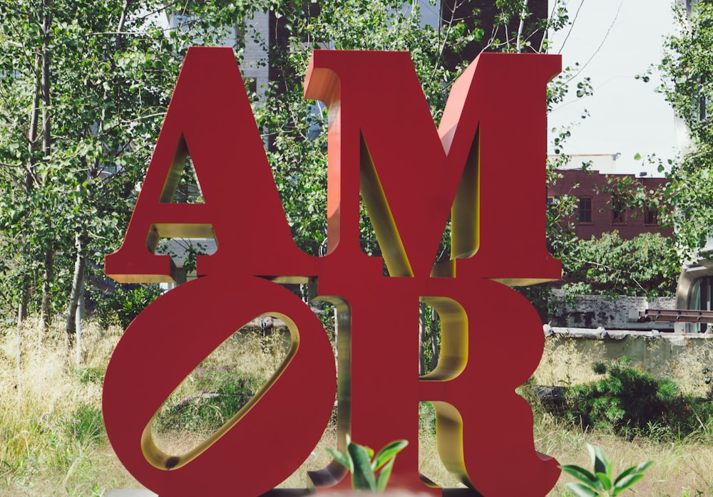 Amor cutout standee beside grass