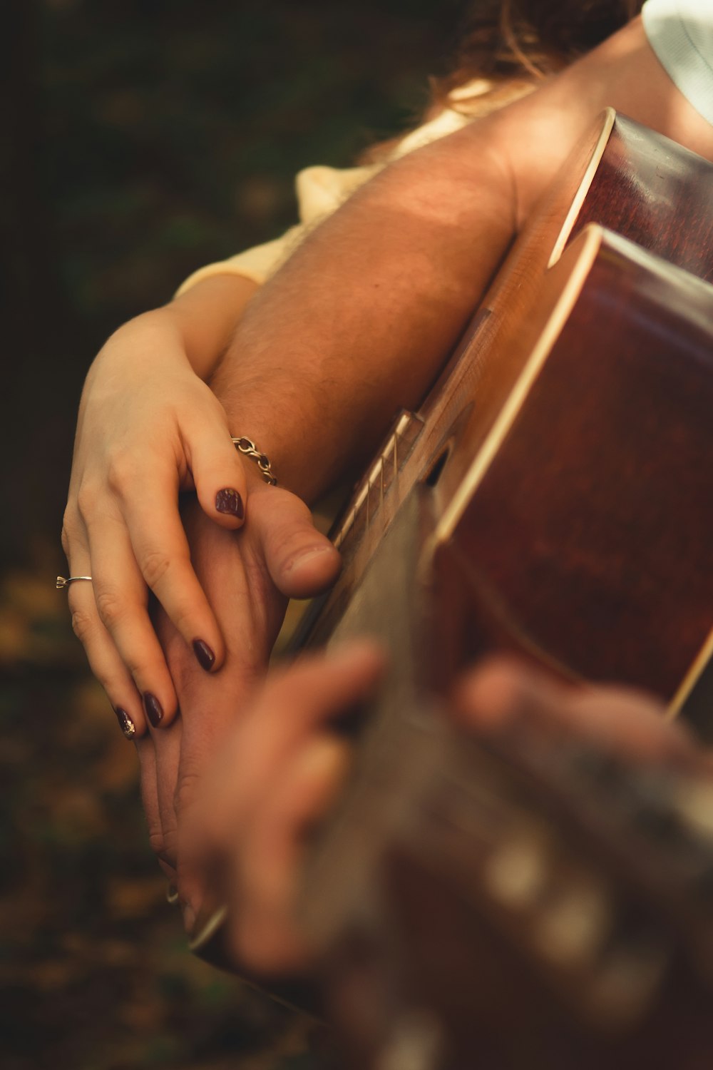 a close up of a person holding a guitar