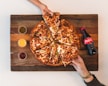 eight sliced pizza with Coca-Cola bottle beside