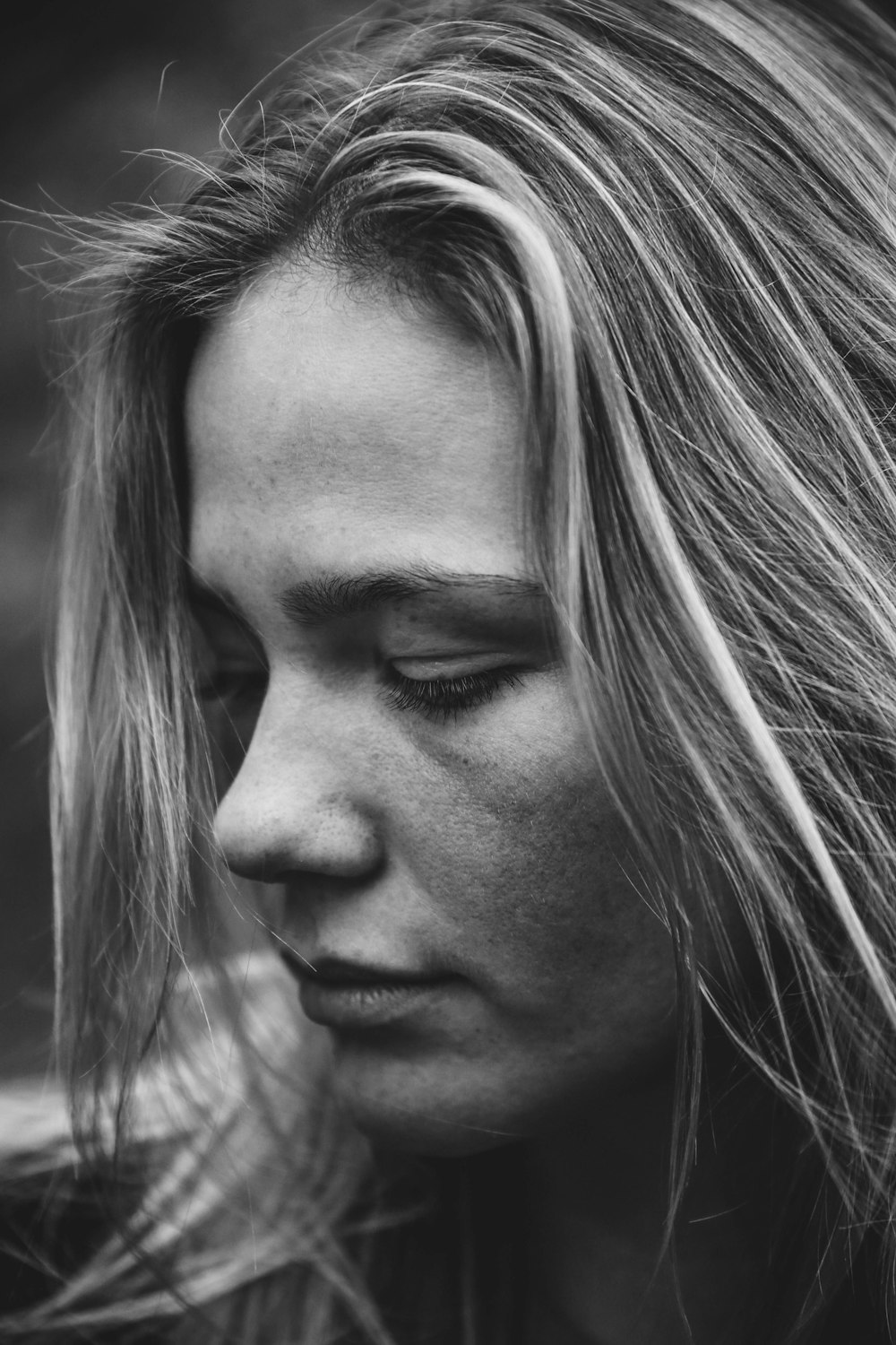 grayscale photography of woman glancing her right side