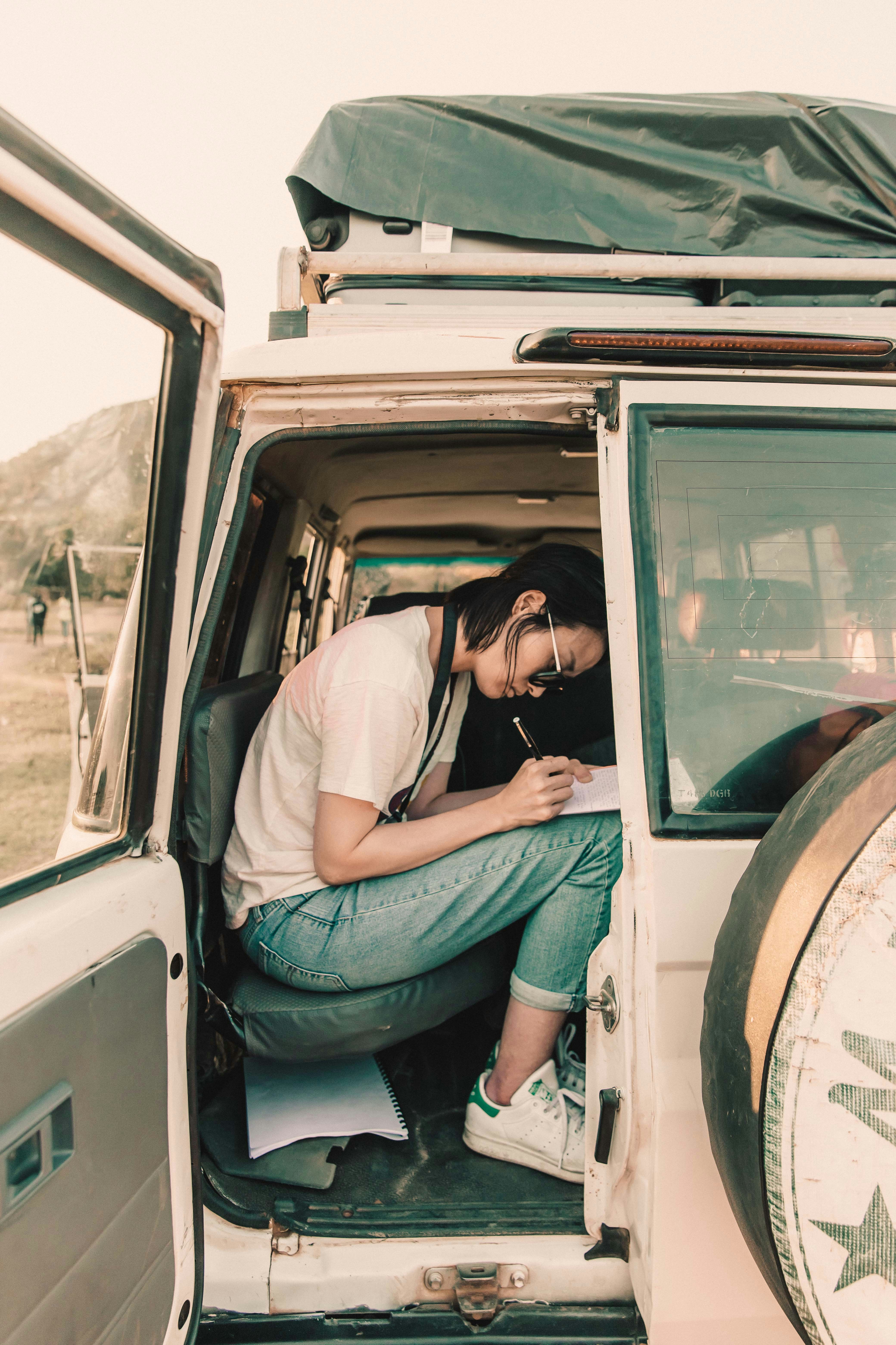 woman siting on vehicle