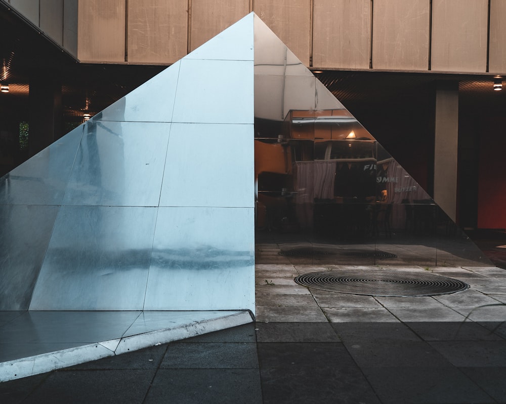 a metal sculpture sitting in front of a building