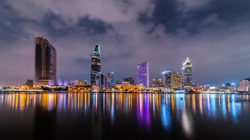 body of water with buildings at distance with light reflection on water surface