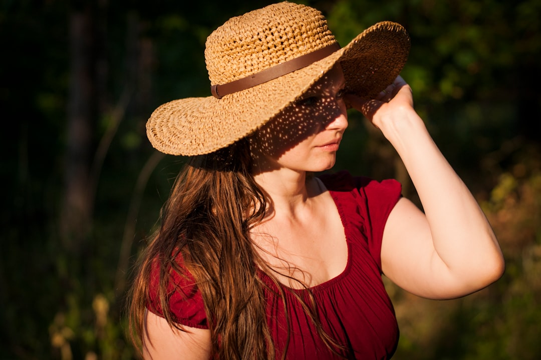 woman holding her hat