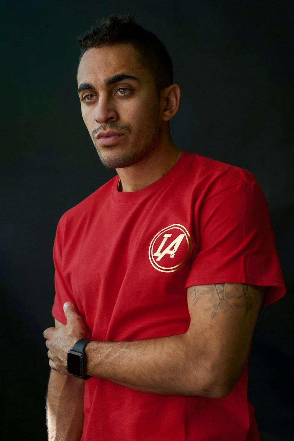 man wearing red with white crew-neck t-shirt standing
