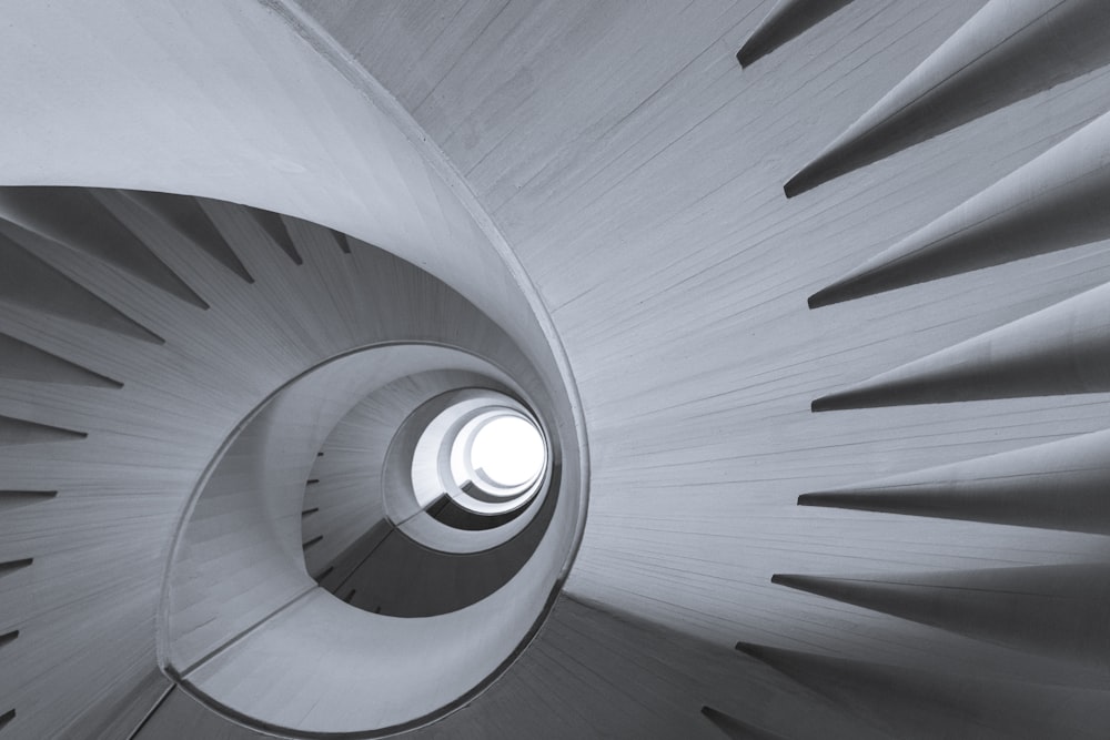 greyscale photography of spiral staircase