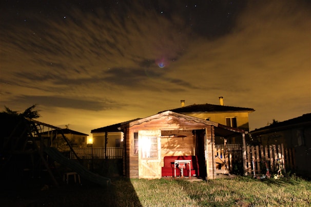Evening shot of a 20ft shed illuminated by warm outdoor lighting, highlighting its clean lines.